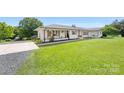 Stylish home featuring a white brick exterior and a lush green front lawn at 5710 Lander Benton Rd, Unionville, NC 28110