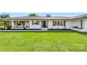 Charming white brick home with a black front door and large green front lawn at 5710 Lander Benton Rd, Unionville, NC 28110