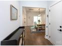Open-concept foyer with hardwood floors leads to the dining area, showcasing modern design at 5777 Stephanie St, Charlotte, NC 28212