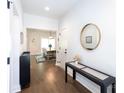 Bright foyer features hardwood floors, modern decor, and a glimpse of the adjacent dining area at 5777 Stephanie St, Charlotte, NC 28212