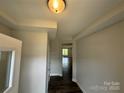 Bright entryway featuring tray ceilings, fresh paint, and hardwood floors, offering a modern welcome at 6256 Culbert St # 187, Harrisburg, NC 28075