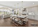 Open-concept kitchen with a large island, pendant lights, flowing into the living room and dining area at 6274 Chimney Bluff Rd, Lancaster, SC 29720