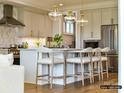 Bright kitchen boasts stainless steel appliances, pendant lighting, and a spacious island with seating at 6274 Chimney Bluff Rd, Lancaster, SC 29720