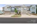 Image of craftsman style townhomes with attached garages, landscaping, and curb appeal at 8221 Houser St, Cornelius, NC 28031