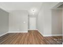Bright living room with hardwood floors and a white front door, ready for personalization at 8309 Emily Dr, Harrisburg, NC 28075