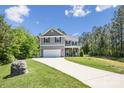 Two-story home with a well-manicured lawn, two-car garage, and inviting curb appeal at 9115 Providence S Rd, Waxhaw, NC 28173