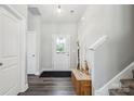 Inviting foyer with hardwood floors, coat closet, and staircase, offering a warm welcome at 9115 Providence S Rd, Waxhaw, NC 28173