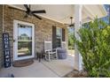 Cozy front porch with rocking chairs, brick accents, ceiling fans, and welcoming decor at 9115 Providence S Rd, Waxhaw, NC 28173