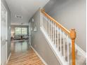 Entryway showing the staircase with natural wood handrail leading to the living area and front door at 10421 Columbia Crest Ct, Charlotte, NC 28270