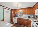 Functional kitchen with wood cabinets, white appliances, subway tile backsplash, and a double sink at 105 Carrie Ln # 3, Cherryville, NC 28021