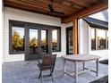 Covered patio features a ceiling fan, cedar ceiling, and a stone tile floor for outdoor relaxation and entertaining at 114 Wilharr Ct # 38, Mooresville, NC 28115