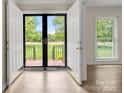 Inviting entryway with double doors, beautiful floors, and plenty of natural light at 12117 Idlewild Rd, Matthews, NC 28105