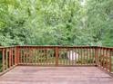 Spacious back deck overlooking a serene wooded area, perfect for outdoor relaxation at 12317 Panthersville Dr, Charlotte, NC 28269