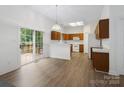Open-concept kitchen and dining area with a sliding door to the back deck at 12317 Panthersville Dr, Charlotte, NC 28269