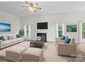 Bright living room features a decorative fireplace, plush seating, and modern decor at 12317 Panthersville Dr, Charlotte, NC 28269