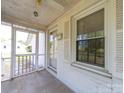 View of a cozy screened porch featuring white trim, concrete floor, and large window overlooking the yard at 1468 Hilltop St, Albemarle, NC 28001