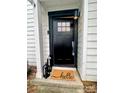 Inviting front door with a 'hello' mat and stylish lantern accents at 1533 Briar Creek Rd # A, Charlotte, NC 28205