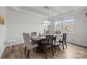 Elegant dining room featuring a dark wood table, neutral upholstered chairs, and a modern chandelier at 1601 Calder Dr, Indian Trail, NC 28079