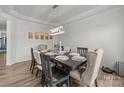 This elegant dining room is complete with an updated chandelier, wood floors and seating for six at 1601 Calder Dr, Indian Trail, NC 28079