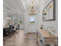 Bright foyer with modern chandelier, wood floors, and dining area; offering a welcoming entrance at 1601 Calder Dr, Indian Trail, NC 28079