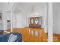 Grand foyer featuring hardwood floors, soaring ceilings, and a view into the living space at 16108 Woolwine Rd, Charlotte, NC 28278