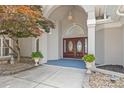 Elegant front entrance with double doors, detailed trim, and manicured landscaping at 16108 Woolwine Rd, Charlotte, NC 28278