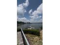 Scenic water view with docks and boat, plus a bridge in the distance, viewed from stone steps at 16108 Woolwine Rd, Charlotte, NC 28278