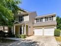 Well-maintained home with a two-car garage, tidy landscaping, and neutral siding at 17204 Caldwell Track Dr, Huntersville, NC 28078