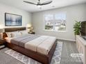 Comfortable bedroom with a large window, wooden furniture, stylish decor, and soft lighting at 1723 Loggerhead Dr, Lancaster, SC 29720
