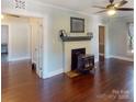 Cozy living room features hardwood floors, a fireplace, and neutral paint at 208 N 5Th St, Albemarle, NC 28001