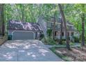 A beautiful two-story home featuring an attached garage and surrounded by mature trees at 2310 Vestry Pl, Charlotte, NC 28270