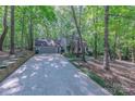A lovely two-story home featuring an attached garage, surrounded by beautiful trees and a long driveway at 2310 Vestry Pl, Charlotte, NC 28270