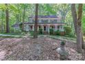 Charming two-story home with a welcoming front porch, surrounded by lush landscaping and mature trees at 2310 Vestry Pl, Charlotte, NC 28270