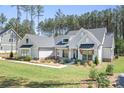 Charming single-Gathering home with a light grey exterior, lovely landscaping, and a luscious green yard at 2396 Lee Lawing Rd, Lincolnton, NC 28092