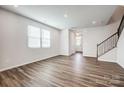Spacious living room features luxury vinyl plank flooring and natural light from large windows at 2405 Hedgecliff Rd, Kannapolis, NC 28025