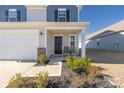 Inviting front entrance with a black door, seating area, and well-manicured landscaping at 2754 Legacy Ridge Ln, Catawba, NC 28609