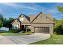 Attractive home with a well-manicured lawn, a two-car garage, and inviting front porch under a bright, sunny sky at 3424 Saint Clair Nw Ct, Concord, NC 28027