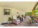 Relaxing outdoor covered porch featuring outdoor furniture, plants, and wooded views at 3755 River Rd, Richfield, NC 28137