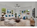 Bright living room with large windows, modern furniture, ceiling fan, and light wood floors at 518 Herms Ave, Mount Holly, NC 28120