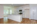 Bright, modern kitchen with stainless steel appliances, granite countertops, and a large center island at 5523 Pamplona Way, Charlotte, NC 28214