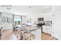 Bright kitchen with white cabinetry, stainless steel appliances, and a large island perfect for entertaining at 5536 Pamplona Way, Charlotte, NC 28214