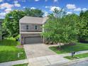Beautiful two-story brick home with a well-manicured lawn and paved driveway at 5633 Open Book Ln, Charlotte, NC 28270