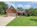Charming brick home with well-manicured lawn and attached two-car garage at 600 Old Hardin Rd, Dallas, NC 28034