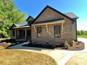 Beautiful exterior shot featuring brick accents, a covered porch and well maintained landscaping at 603 Turnberry Ct, Albemarle, NC 28001