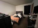 Bedroom with bed, wood headboard, and dresser at 6134 Bent Tree Ct, Charlotte, NC 28212