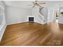 Open concept living area featuring beautiful hardwood floors and a fireplace at 6457 Saint Bernard Way, Charlotte, NC 28269