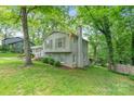 Two story home with a brick chimney, manicured lawn, and mature trees at 6609 Pleasant Dr, Charlotte, NC 28211