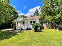 Quaint single-story home with a well-manicured lawn, mature trees, and inviting front porch at 736 7Th Sw Ave, Hickory, NC 28602