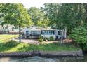 Rear view of lakeside home with a private deck and stone retaining wall at 9115 Clement Cir, Terrell, NC 28682