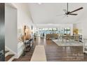 Open floor plan with dark hardwood floors and expansive lake view windows at 9115 Clement Cir, Terrell, NC 28682